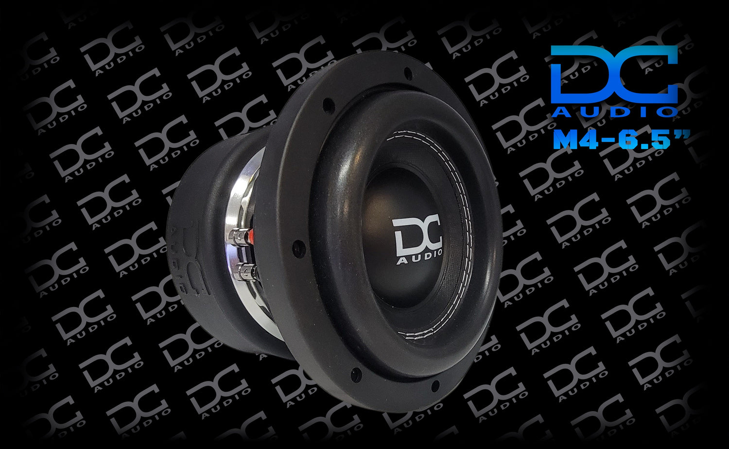 DC Audio M4 6.5 inch Subwoofer with a black aluminum frame and a white DC logo on the dust cover.