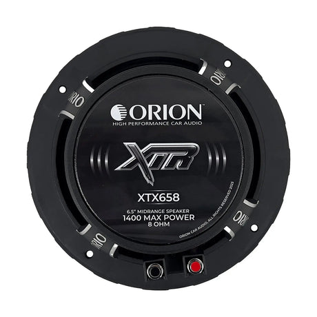 Rear view of the Orion XTX658 6.5-inch 8-ohm midrange speaker, highlighting the large ferrite magnet and vented backplate for improved heat dissipation. The cast aluminum frame and gold-plated speaker terminals are visible, designed for secure, high-conductivity connections. The back label includes key specs and branding details. This image is perfect for displaying the technical build quality on LibertyBassShop.com.