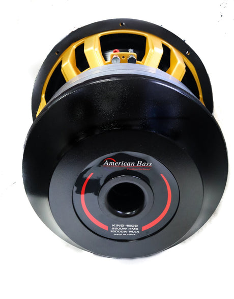 An American Bass King 15 inch subwoofer with a black and yellow voice coil, carbon cone, and a black anodized cooling system.